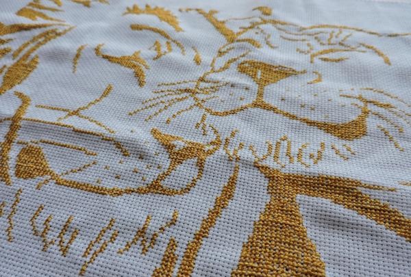 Embroidering a pair of golden lions