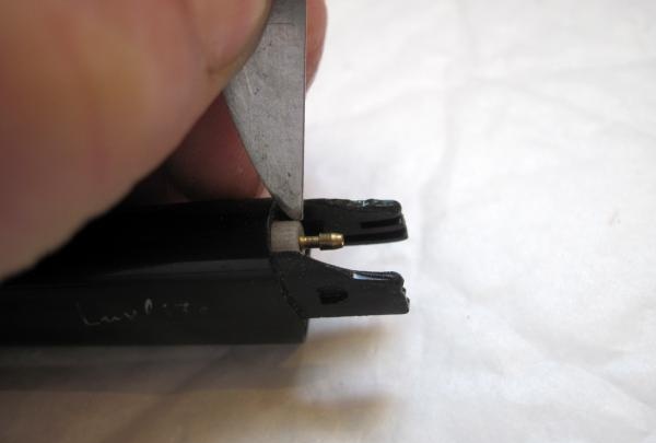 unscrew the adjusting screw