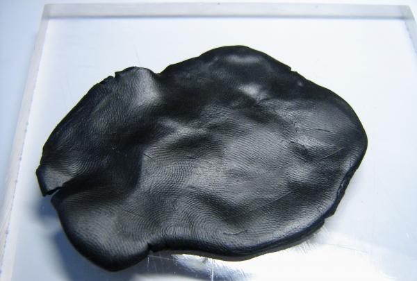 Knead black clay into a layer