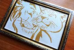 Embroidering a pair of golden lions