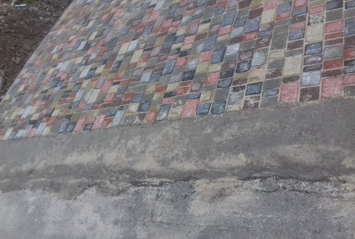 Driveway to the house made of paving slabs