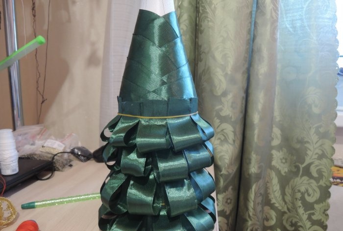 Champagne dressed up as a Christmas tree for the New Year's table