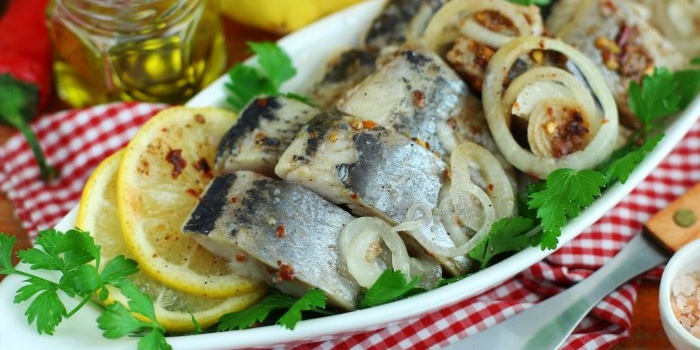 Herring marinated in a jar with spices and lemon