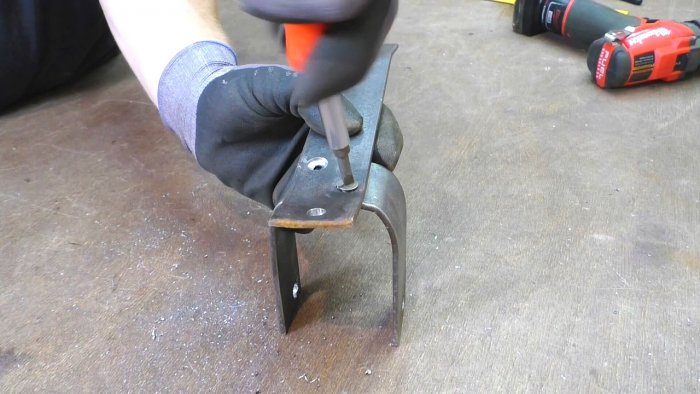 Stand for an angle grinder made from the handle of a children's bicycle