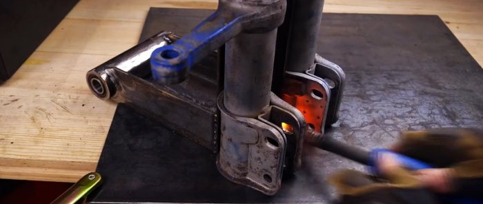 How to make a cutting machine from an angle grinder and old shock absorbers