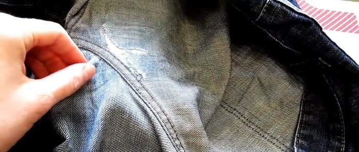 The jeans are turned inside out and the edges of the hole are smoothed out with an iron.