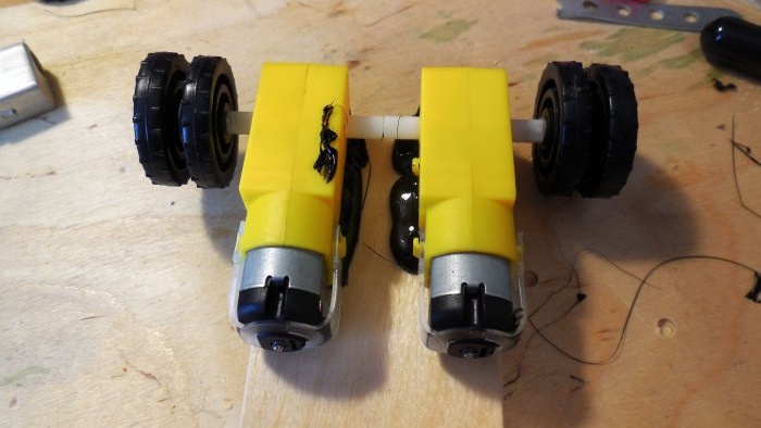 The motors are mounted on a piece of durable plywood.