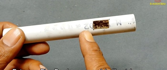 a hole is cut in a piece of plastic tube for the switch