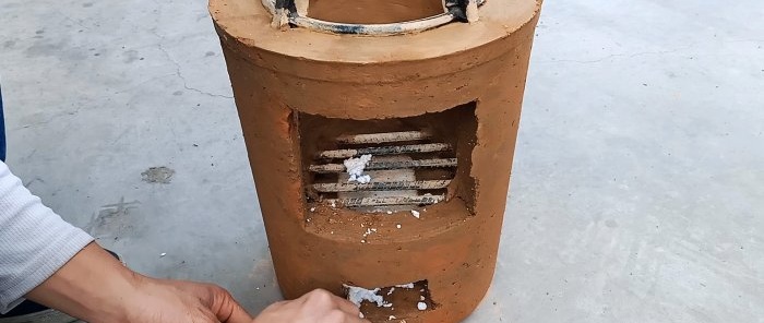 After the solution has dried, the plastic bucket is cut and the stove is removed